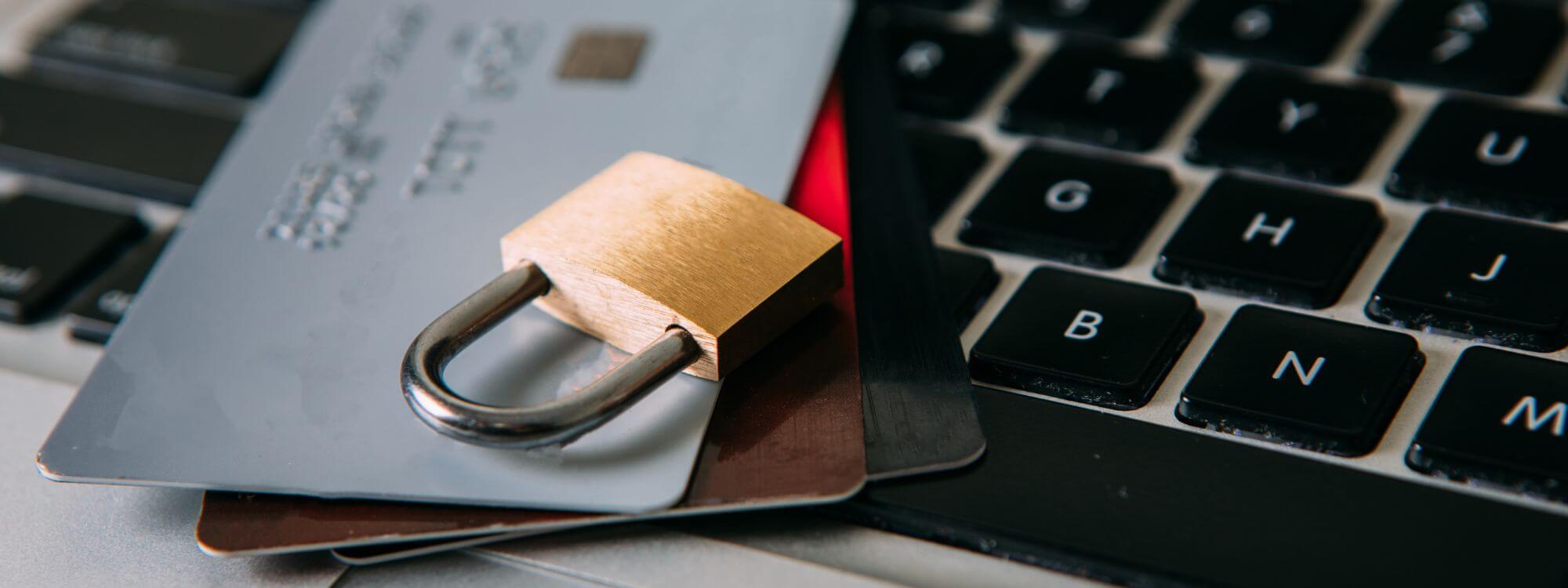 Banner for fraud protection featuring credit cards, keyboard and a lock.